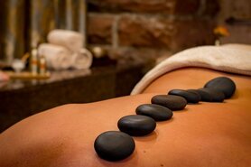 Hot stones placed on back for massage treatment